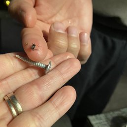 a man holding a screw in his hand