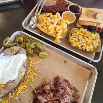 J-Bar-M Barbecue - Loaded baked potato with chopped brisket, chopped brisket sandwich, mac, jalapeño cheese sausage and elote. - Barbeque Near Me - Houston, Texas J-Bar-M Barbecue - Loaded baked potato with chopped brisket, chopped brisket sandwich, mac, jalapeño cheese sausage and elote. - Barbeque Near Me - Houston, Texas