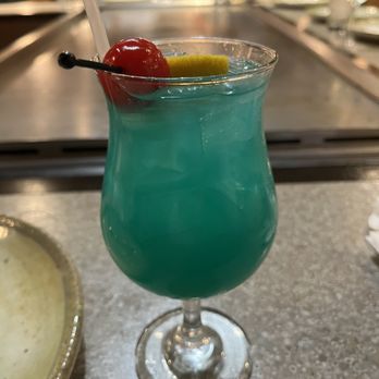 Feng Shui - a blue cocktail with a cherry garnish - Sushi Bars Near Me - Chelmsford, Massachusetts