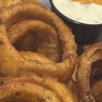 Rosemarie's Buns and Brews - BEER-BATTERED ONION RINGS (hold the paprika) with ranch and chipotle aioli dip - Burgers Near Me - Encinitas, California Rosemarie's Buns and Brews - BEER-BATTERED ONION RINGS (hold the paprika) with ranch and chipotle aioli dip - Burgers Near Me - Encinitas, California