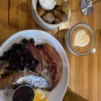 The Mud House - Half order of French toast with blueberries. A side of potatoes and bacon with an oat milk latte. - Coffee & Tea Near Me - Saint Louis, Missouri