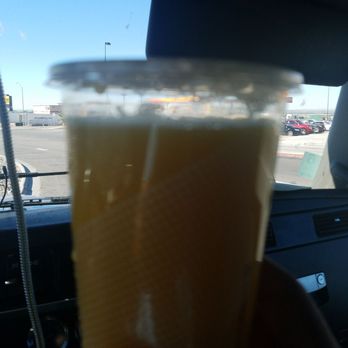 McDonald's - a hand holding a cup of orange juice - Burgers Near Me - Anthony, Texas