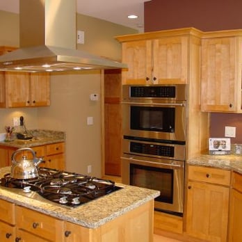 Basso Builders Inc. - a kitchen with wood cabinets and a stove - General Contractors Near Me - Lake Geneva, Wisconsin Basso Builders Inc. - a kitchen with wood cabinets and a stove - General Contractors Near Me - Lake Geneva, Wisconsin