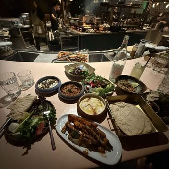 Maydan Market - TAWLE: THE FULL MAYDÄ€N EXPERIENCE, MEANT TO BE SHARED The spread that comes with it in from of the open grill kitchen - Bars Near Me - Los Angeles, California Maydan Market - TAWLE: THE FULL MAYDÄ€N EXPERIENCE, MEANT TO BE SHARED The spread that comes with it in from of the open grill kitchen - Bars Near Me - Los Angeles, California