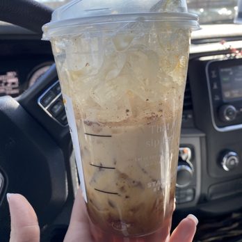 Starbucks - a hand holding a cup of iced coffee - Coffee & Tea Near Me - Riverhead, New York Starbucks - a hand holding a cup of iced coffee - Coffee & Tea Near Me - Riverhead, New York