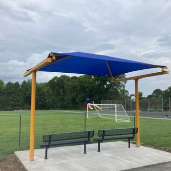 Happy Backyards - Blue cantilever shade structure over park benches. - Kids Activities Near Me - Collierville, Tennessee Happy Backyards - Blue cantilever shade structure over park benches. - Kids Activities Near Me - Collierville, Tennessee