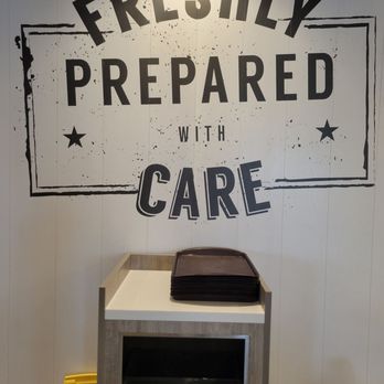 McDonald's - a sign that says freshly prepared with care - Burgers Near Me - Bloomingdale, Illinois
