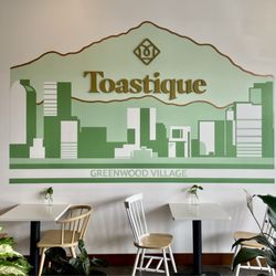 Toastique - Dining area with store name decal on wall