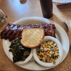 Oakwood Smokehouse - Whole rack of ribs w/ collard greens a roasted corn.