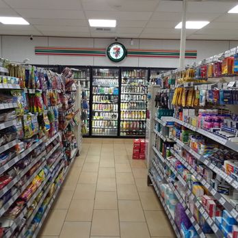 7-Eleven - a supermarket aisle with a clock on the wall - Convenience Stores Near Me - Seattle, Washington