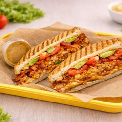 Smoky chipotle chicken, melted cheddar, crispy bacon, creamy avocado, and fresh tomato, pressed on sweet Mexican panini bread