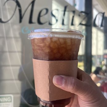 Mestiza Coffeehouse - Americano with stirred (not shaken) orange syrup. - Bakeries Near Me - Ontario, California Mestiza Coffeehouse - Americano with stirred (not shaken) orange syrup. - Bakeries Near Me - Ontario, California