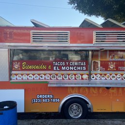 a man standing in front of a food truck a man standing in front of a food truck
