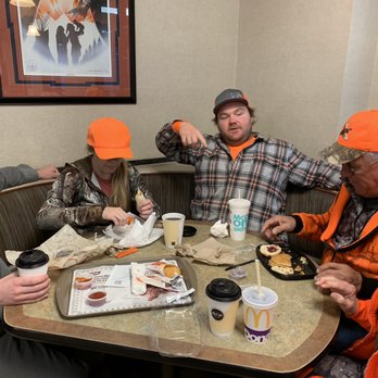McDonald's - a group of people sitting around a table - Burgers Near Me - Pierre, South Dakota