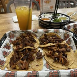 Tacos al pastor with pineapple and mango agua fresca.