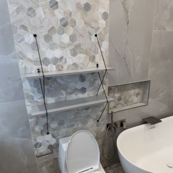 Smart Solutions - a toilet and a bathtub in a bathroom - Flooring Near Me
