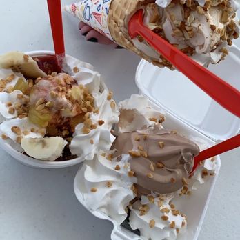 Dairy Shack - a hand holding a scoop of ice cream and a container of banana split - Ice Cream & Frozen Yogurt Near Me - Eminence, Missouri Dairy Shack - a hand holding a scoop of ice cream and a container of banana split - Ice Cream & Frozen Yogurt Near Me - Eminence, Missouri