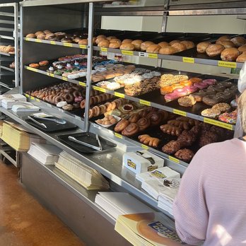 Daylight Donuts - a woman standing in front of a display of donuts - Donuts Near Me - Jarrell, Texas Daylight Donuts - a woman standing in front of a display of donuts - Donuts Near Me - Jarrell, Texas