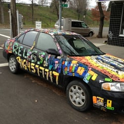 Wireless World - Car covered with phone cases outside Wireless World