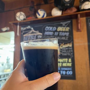 Wild River Pizza - a hand holding a glass of beer - Pizza Near Me - Brookings Harbor, Oregon Wild River Pizza - a hand holding a glass of beer - Pizza Near Me - Brookings Harbor, Oregon