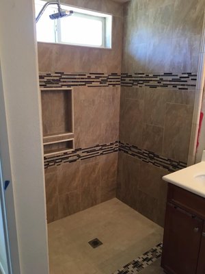 Shower Transformation - We deliver quality that lasts! Check out this incredible shower and floor transformation—turning an outdated bathroom into a clean, modern space. Ready to transform your bathroom? Call IronBuilt today for your FREE remodeling proposal!