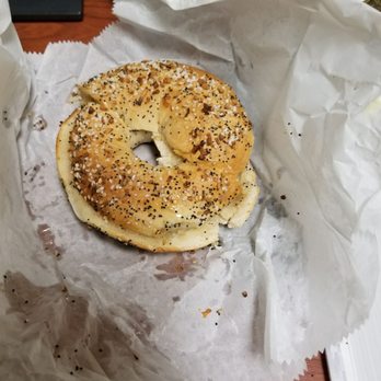 Bagel Stop - a bagel on a piece of wax paper - Bagels Near Me - Hauppauge, New York