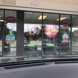 Best In Town Cleaners - Front window showing specials
