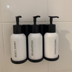 Corona Hotel - Large shampoo and conditioner bottles in the shower.