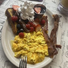 The Valentine's Day special. Two eggs, 2 bacon, and 1/2 order of French toast topped with berries and whipped cream. Delicious! The Valentine's Day special. Two eggs, 2 bacon, and 1/2 order of French toast topped with berries and whipped cream. Delicious!