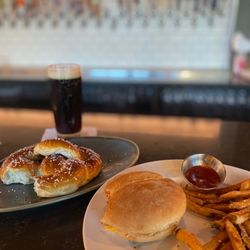 Beerstyles Taproom and Gastropub - Soft pretzel appetizer (only 1 of 2 left) and burger (forget which one) and fries.