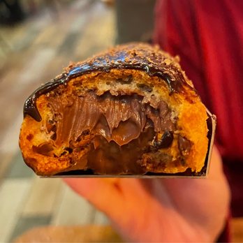Petit Chou - Cross section of Chocolate Eclair - all that gloriously decadent filling - Bakeries Near Me - New York, New York Petit Chou - Cross section of Chocolate Eclair - all that gloriously decadent filling - Bakeries Near Me - New York, New York
