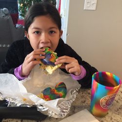 Rainbow bagel with her rainbow cup
