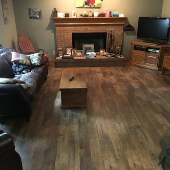 Perfected Flooring - a living room with a fireplace - Flooring Near Me Perfected Flooring - a living room with a fireplace - Flooring Near Me