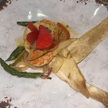 Kalalou Signature - Conch, Shrimp in a hibiscus butter and garlic sauce, sitting on malanga crispers. - African Near Me - Orlando, Florida Kalalou Signature - Conch, Shrimp in a hibiscus butter and garlic sauce, sitting on malanga crispers. - African Near Me - Orlando, Florida