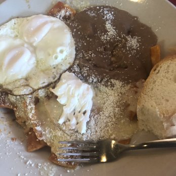 Los Chilakillers - Chilaquiles plate with an egg sunny side up and refried beans with cheese - Mexican Near Me - Austin, Texas Los Chilakillers - Chilaquiles plate with an egg sunny side up and refried beans with cheese - Mexican Near Me - Austin, Texas