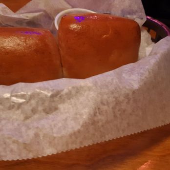 Texas Roadhouse - 2 of the 4 rolls with butter - Steakhouses Near Me - Macon, Georgia