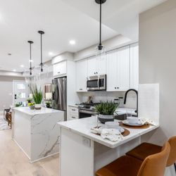 NoCa Cabinets - - J&K S8-White Shaker Cabinets
- Quartz Countertops with Waterfalls on the Island