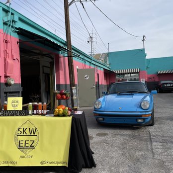 Skweez Juicery - a blue car parked in front of a store - Juice Bars & Smoothies Near Me Skweez Juicery - a blue car parked in front of a store - Juice Bars & Smoothies Near Me