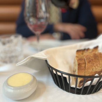 Place Carmin - a basket of bread and a glass of wine - French Near Me - Montreal, Quebec