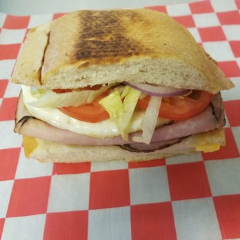 The Last Taino - a sandwich on a checkered tablecloth - Caribbean Near Me The Last Taino - a sandwich on a checkered tablecloth - Caribbean Near Me