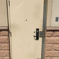 AM&PM Calgary Locksmith - Installing a heavy duty mechanism and plate on an commercial door