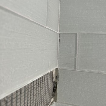 Task Flooring - a hole in the wall of a bathroom - Flooring Near Me
