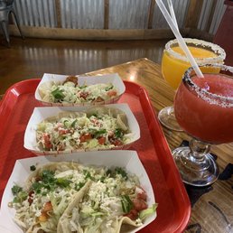 Fish tempura, shredded chicken, and ground beef tacos on corn tortillas