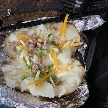 Outback Steakhouse - A baked potato with a couple shreds of cheese and hardly any bacon. GREAT toppings - Steakhouses Near Me - Fort Worth, Texas Outback Steakhouse - A baked potato with a couple shreds of cheese and hardly any bacon. GREAT toppings - Steakhouses Near Me - Fort Worth, Texas
