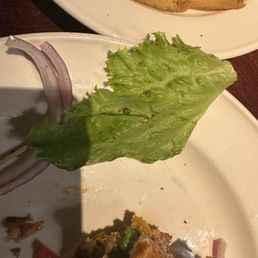 Holes and rotten leafs of salad on the burger Holes and rotten leafs of salad on the burger