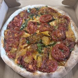 Tony's Pizza - Specialty pie - august/'26 - Heirloom tomato confit pie. Tomatoes slow roasted until sweet. Then baked with fresh basil and oregano.