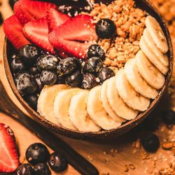 Original Acai - American Bowl. Organic açaí topped with fresh strawberries, blueberries, bananas granola and honey.