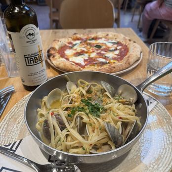 Claudios Table - Margherita pizza In the back and linguini alle vongole in the front - Italian Near Me - Washington, DC, District of Columbia Claudios Table - Margherita pizza In the back and linguini alle vongole in the front - Italian Near Me - Washington, DC, District of Columbia