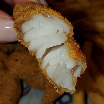 Shrimp Basket - a hand holding a piece of fried fish - Seafood Near Me - Orange Beach, Alabama