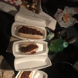 three hot dogs with chili on them three hot dogs with chili on them